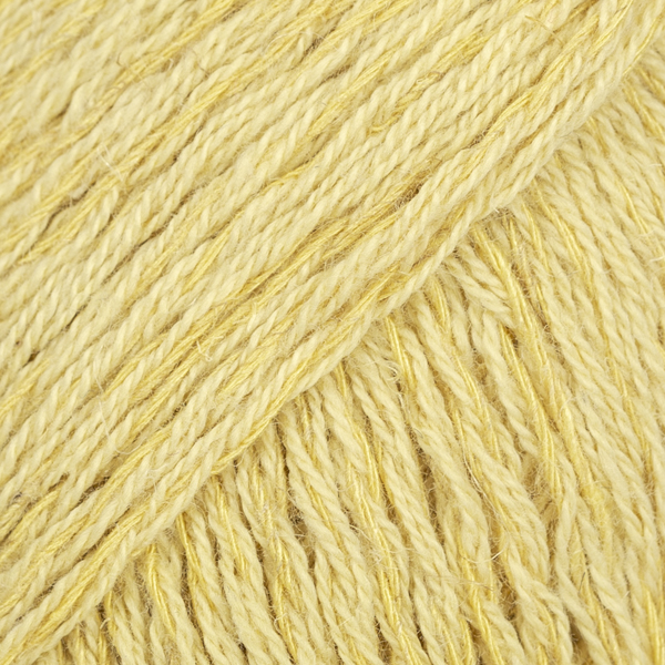 Yellow yarn with golden strands close up